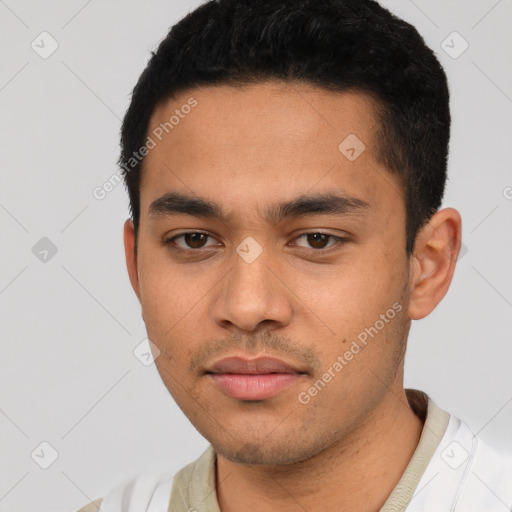 Neutral latino young-adult male with short  black hair and brown eyes