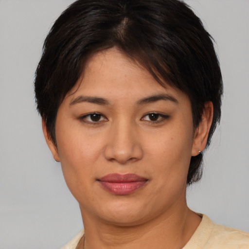 Joyful asian young-adult female with short  brown hair and brown eyes