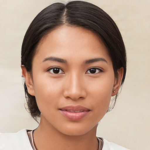 Joyful asian young-adult female with medium  brown hair and brown eyes