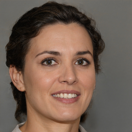 Joyful white adult female with medium  brown hair and brown eyes