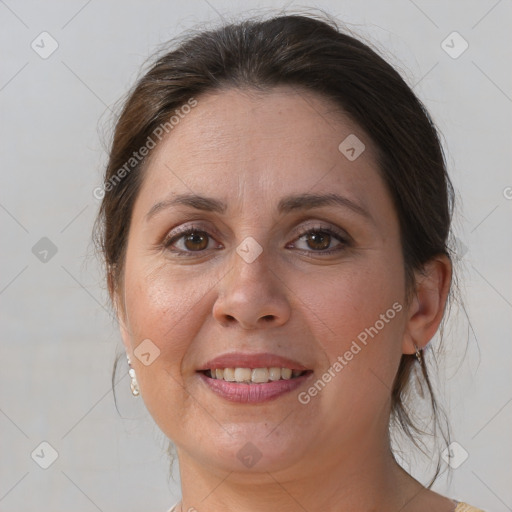 Joyful white adult female with medium  brown hair and brown eyes