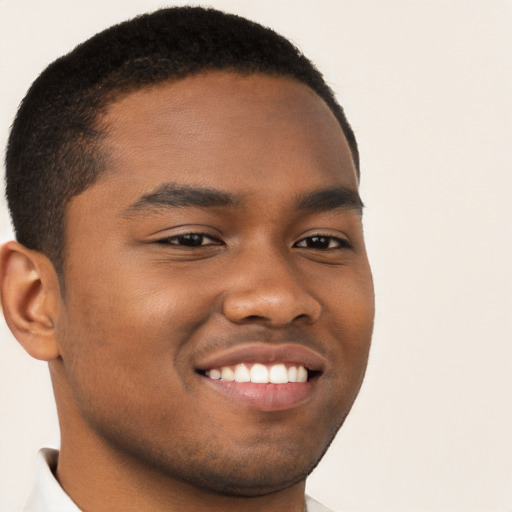 Joyful black young-adult male with short  brown hair and brown eyes