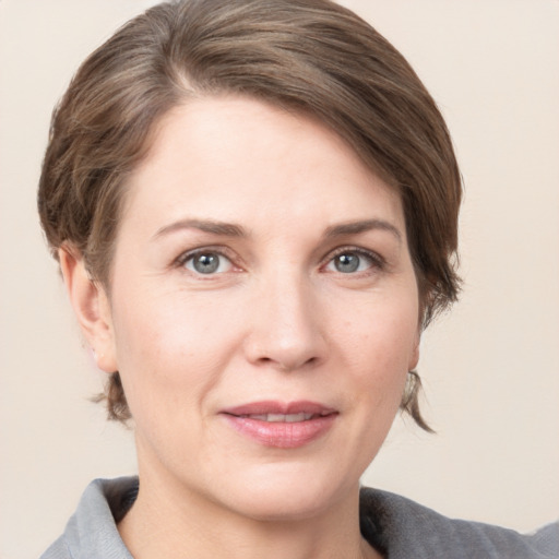 Joyful white adult female with medium  brown hair and grey eyes