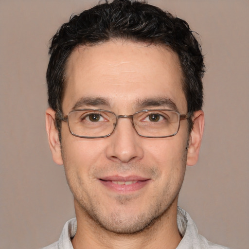 Joyful white adult male with short  brown hair and brown eyes