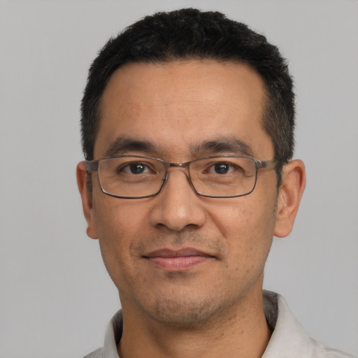Joyful white adult male with short  black hair and brown eyes