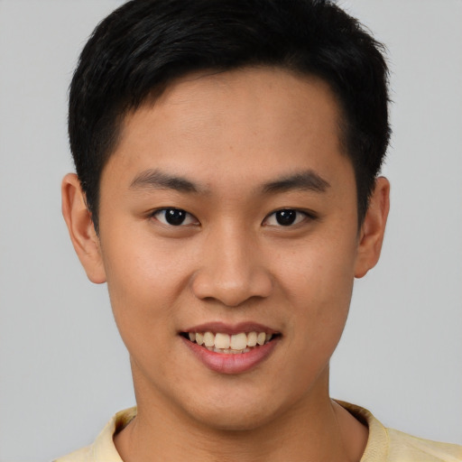 Joyful latino young-adult male with short  brown hair and brown eyes