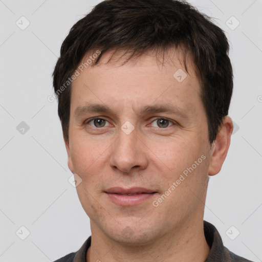 Joyful white adult male with short  brown hair and brown eyes