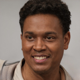 Joyful latino young-adult male with short  brown hair and brown eyes