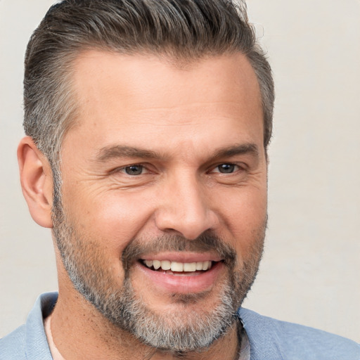 Joyful white adult male with short  brown hair and brown eyes