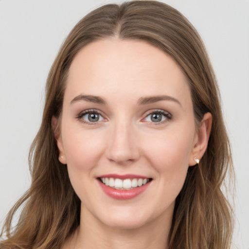 Joyful white young-adult female with long  brown hair and grey eyes