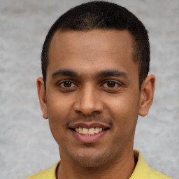 Joyful latino young-adult male with short  black hair and brown eyes