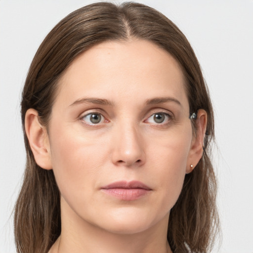 Joyful white young-adult female with long  brown hair and grey eyes