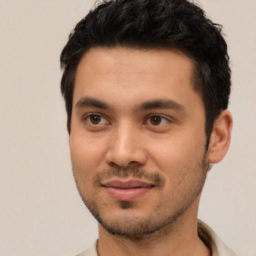 Joyful white young-adult male with short  black hair and brown eyes