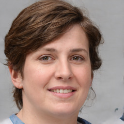 Joyful white young-adult female with medium  brown hair and blue eyes