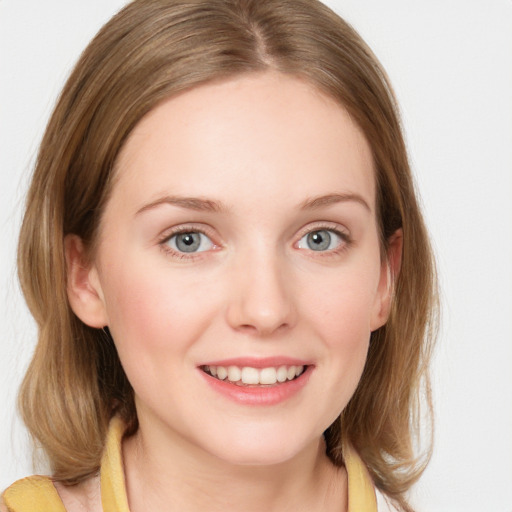 Joyful white young-adult female with medium  brown hair and blue eyes