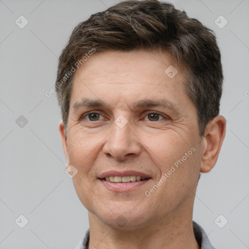 Joyful white adult male with short  brown hair and brown eyes