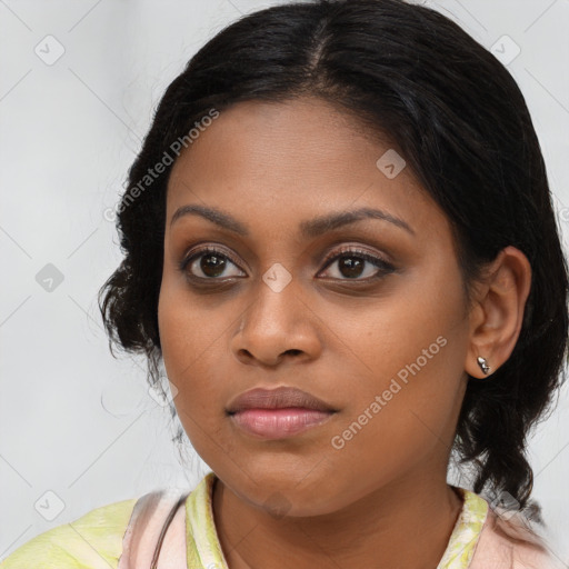 Joyful black young-adult female with medium  brown hair and brown eyes