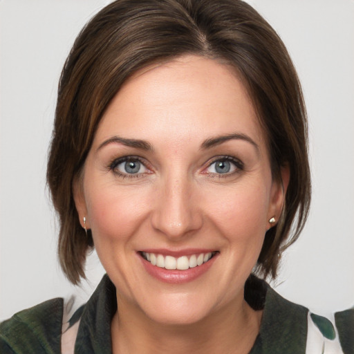 Joyful white young-adult female with medium  brown hair and green eyes