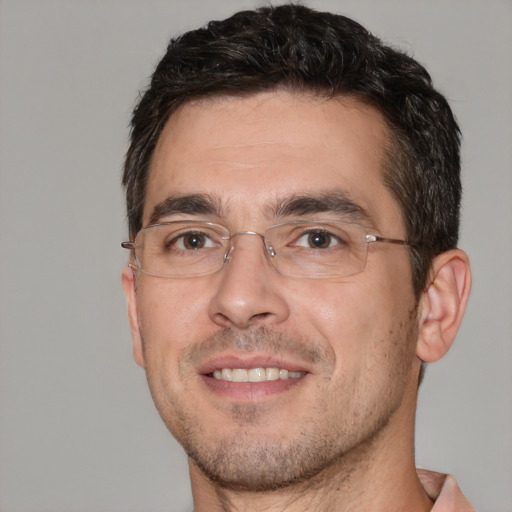 Joyful white adult male with short  brown hair and brown eyes