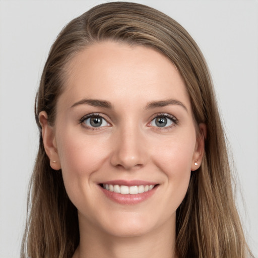 Joyful white young-adult female with long  brown hair and grey eyes