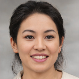 Joyful asian young-adult female with medium  brown hair and brown eyes