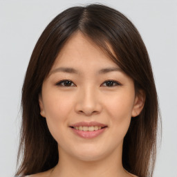 Joyful asian young-adult female with medium  brown hair and brown eyes