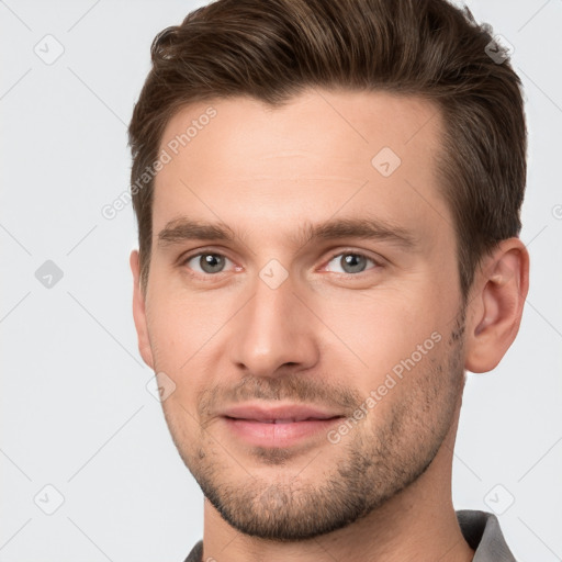 Joyful white young-adult male with short  brown hair and brown eyes