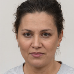 Joyful white adult female with short  brown hair and brown eyes