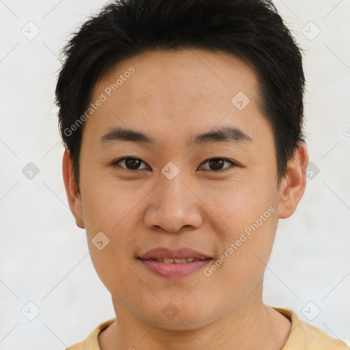 Joyful asian young-adult male with short  brown hair and brown eyes