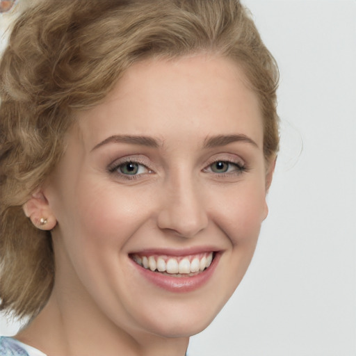 Joyful white young-adult female with medium  brown hair and green eyes