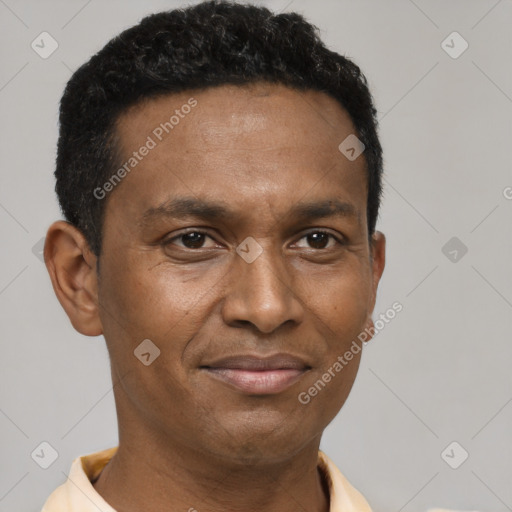 Joyful latino young-adult male with short  brown hair and brown eyes