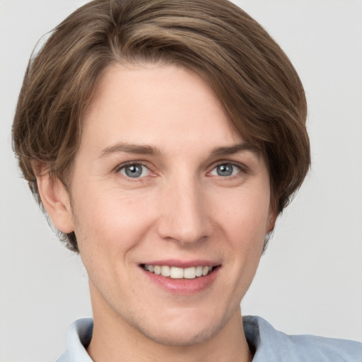 Joyful white young-adult female with short  brown hair and grey eyes