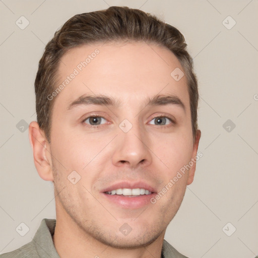 Joyful white young-adult male with short  brown hair and grey eyes