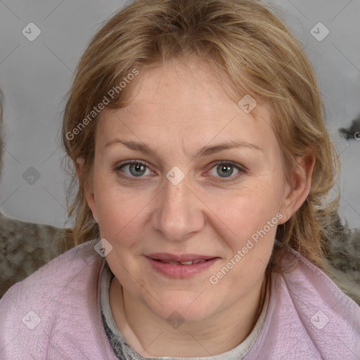 Joyful white adult female with medium  brown hair and blue eyes