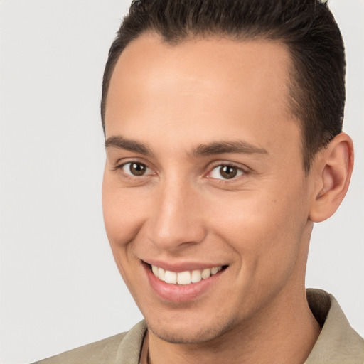 Joyful white young-adult male with short  brown hair and brown eyes