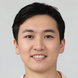 Joyful asian young-adult male with short  black hair and brown eyes