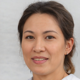 Joyful white adult female with medium  brown hair and brown eyes