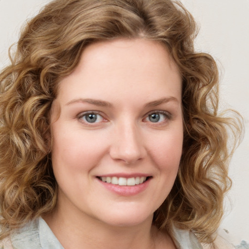 Joyful white young-adult female with medium  brown hair and green eyes