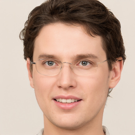 Joyful white young-adult male with short  brown hair and green eyes