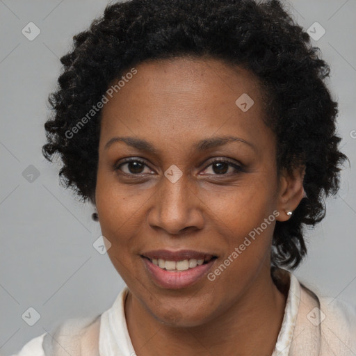 Joyful black adult female with short  brown hair and brown eyes