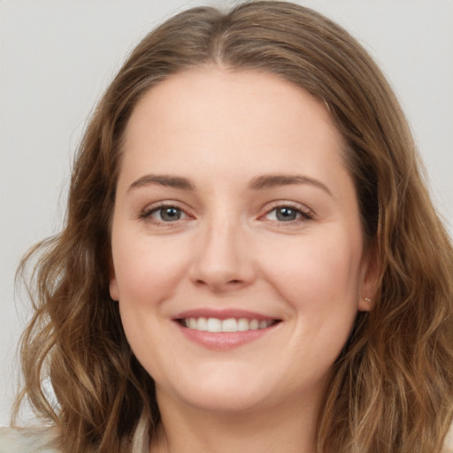 Joyful white young-adult female with long  brown hair and green eyes