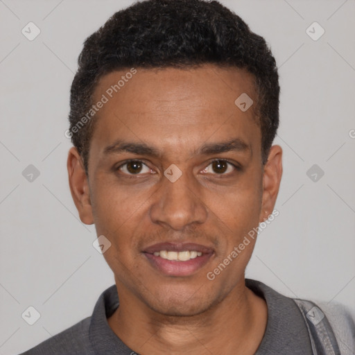 Joyful black young-adult male with short  black hair and brown eyes