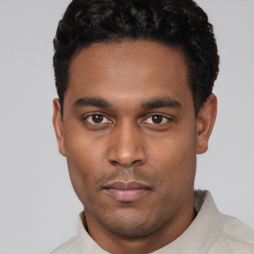 Neutral black young-adult male with short  black hair and brown eyes