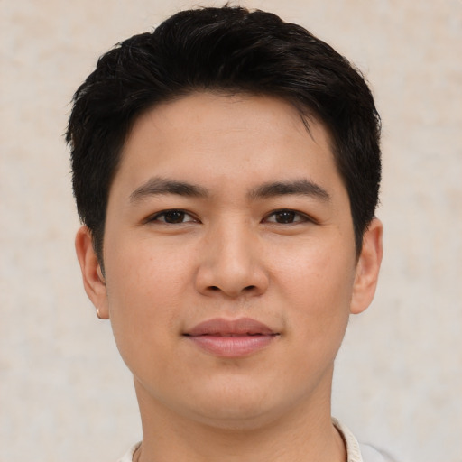 Joyful asian young-adult male with short  brown hair and brown eyes