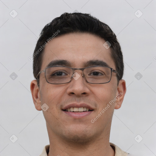 Joyful white young-adult male with short  black hair and brown eyes