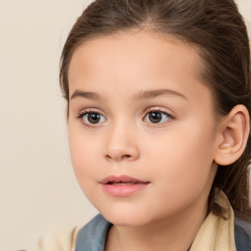 Joyful white child female with long  brown hair and brown eyes