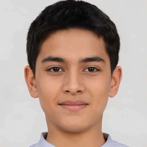 Joyful latino child male with short  black hair and brown eyes