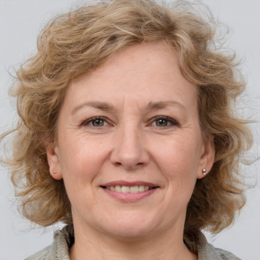 Joyful white adult female with medium  brown hair and grey eyes