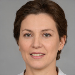 Joyful white adult female with medium  brown hair and grey eyes