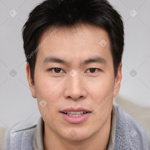 Joyful asian young-adult male with short  brown hair and brown eyes